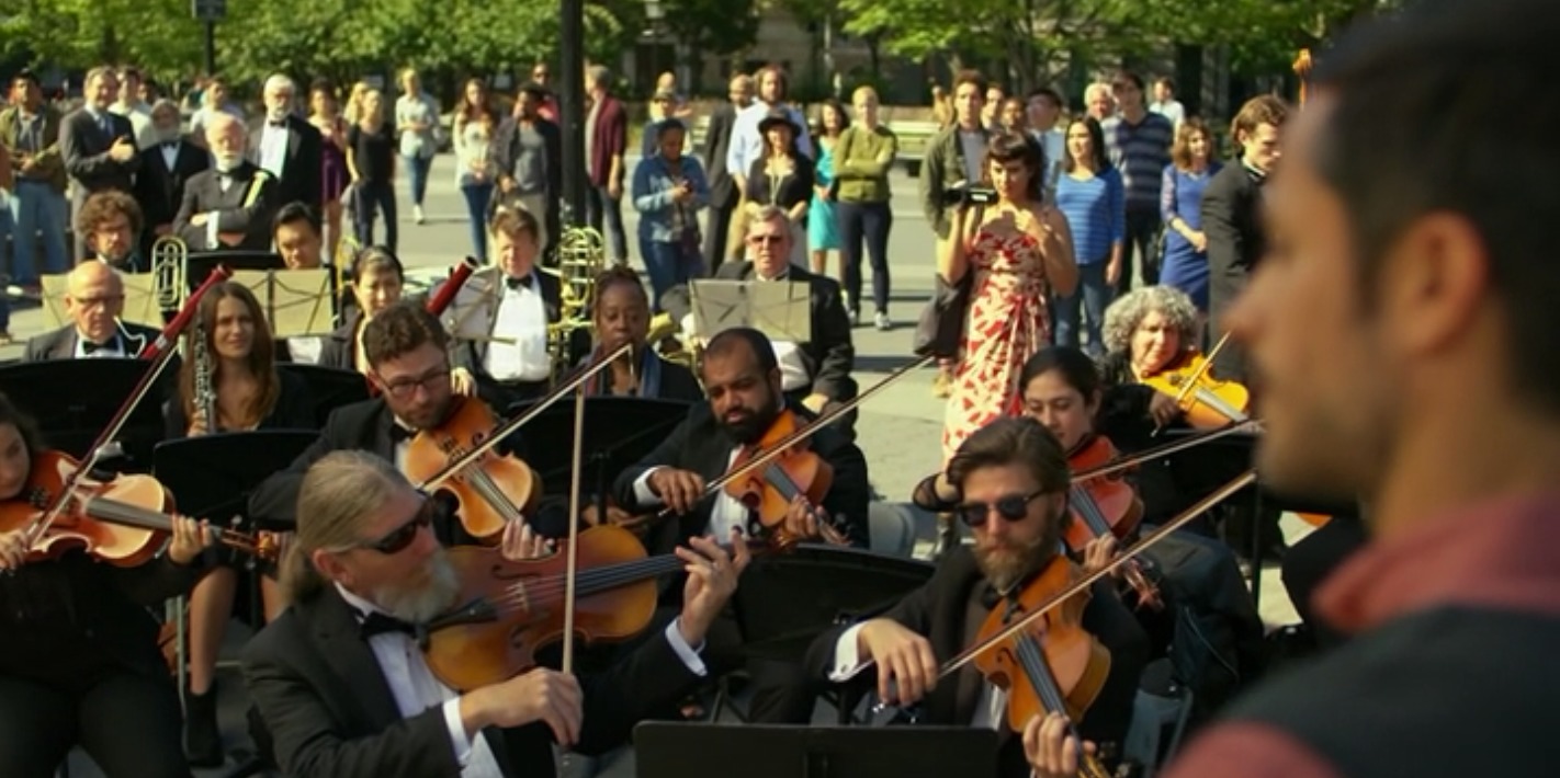 "Home," Mozart in the Jungle. Concert spectator in tuxedo standing behind and to the right of John Miller (Dee Dee) in the upper left corner of the picture. Gael García Bernal (Rodrigo) to the far right. Shot in NYC. 