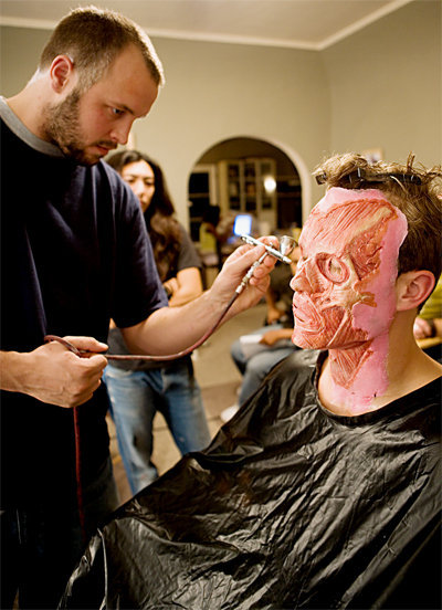 Special effects makeup artist, Patrick Magee, works his magic on actor, Travis Wood.