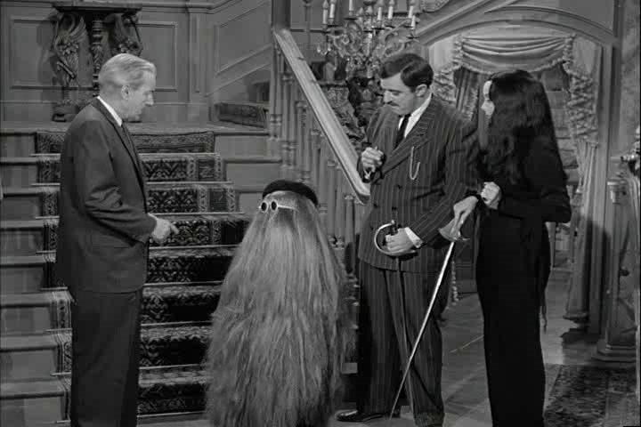 John Astin, Douglas Evans, Carolyn Jones, and Felix Silla in The Addams Family (1964)