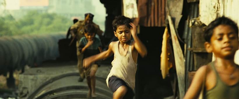 Azharuddin Mohammed Ismail and Ayush Mahesh Khedekar in Slumdog Millionaire (2008)