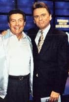 Johnny Gilbert and Pat Sajak in Jeopardy! (1984)