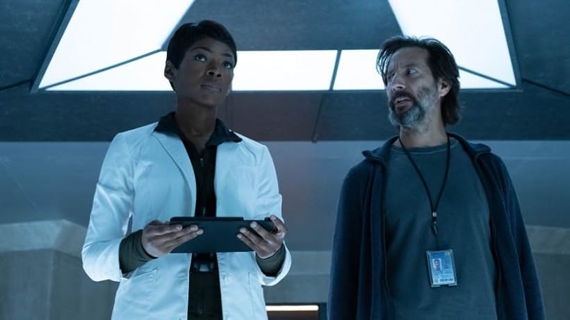 Caroline Chikezie and Henry Ian Cusick in The Passage (2019)