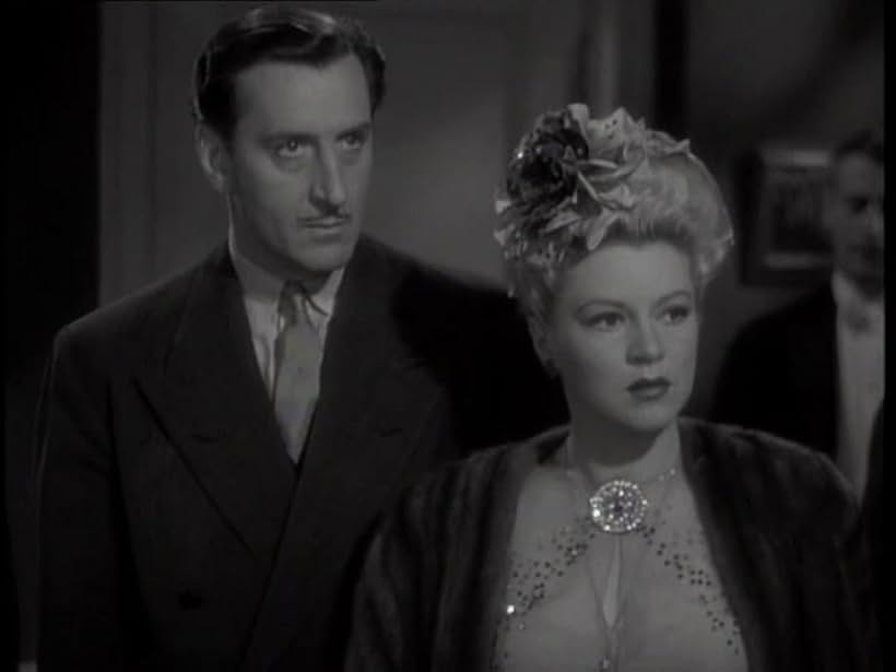 Basil Rathbone and Claire Trevor in Crossroads (1942)