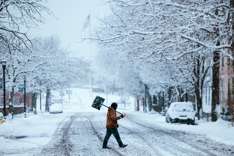 A resident carries a shovel during a storm in Hudson, New York on Jan. 7, 2024. 