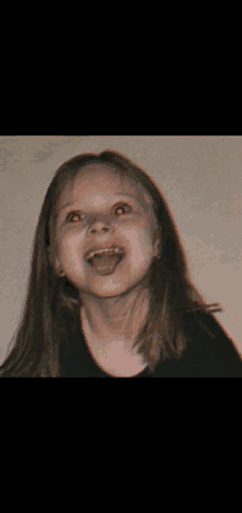 a little girl with red eyes is making a face