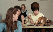 a woman sitting at a table with a plate of food that says micholas c. equality