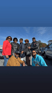 a group of people posing for a picture including a man wearing a blue hoodie that says ' i love you '