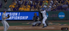 a baseball game is being played in front of a ncaa banner