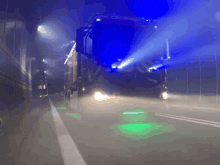 a fire truck is driving down a highway with blue lights shining on it