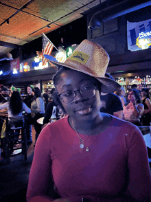 a woman wearing a straw hat with a yellow patch that says " texas "