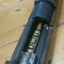 a close up of a rifle with a bullet in it .