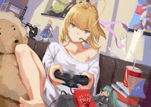 a girl is sitting on a couch playing a video game with a pocky box in front of her