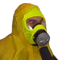 a man wearing a yellow protective suit and a gas mask with the letter g on it