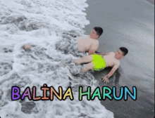 two boys are laying on the beach with the name balina harun written on the bottom