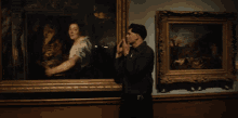 a man is reaching up to touch a painting with his hands