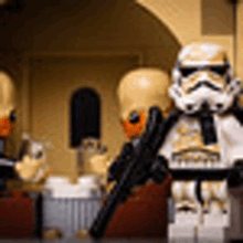 a group of lego stormtroopers are standing next to each other in front of a building holding guns .