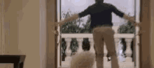 a man is opening a door to a balcony .