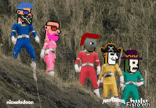 a group of power rangers from nickelodeon are standing on a hill