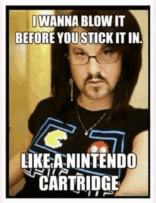 a man with glasses and a mustache is wearing a pacman shirt and a nintendo cartridge .