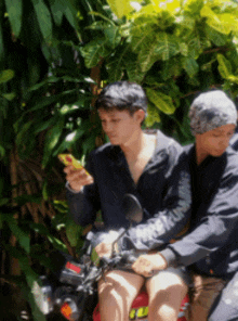 a man on a motorcycle looking at his phone