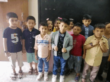 a group of children posing for a picture with the number 5 on their shirt