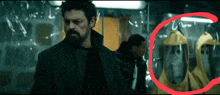 a man with a beard is standing in front of a room with a red circle around it