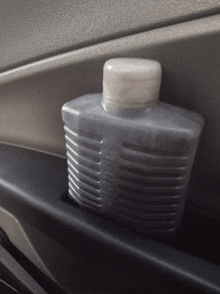 a bottle with the word meiss on it sits in a car door