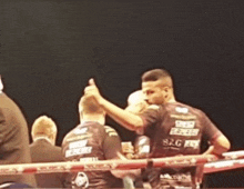 a man in a boxing ring with a shirt that says s2g on it