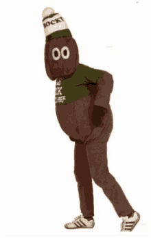 a person in a rocky mascot costume is wearing a green shirt