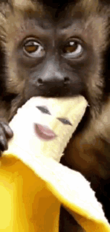 a monkey is eating a banana with a face on it .