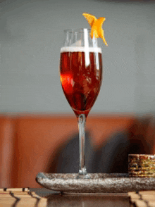 a close up of a wine glass with a drink in it on a tray