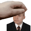 a hand is touching a man 's forehead in a suit and tie