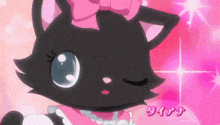 a black cat with a pink bow on its head and a pearl necklace