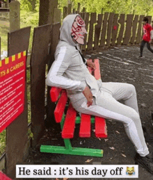 a person sitting on a bench with a sign that says " pets & carers " behind them