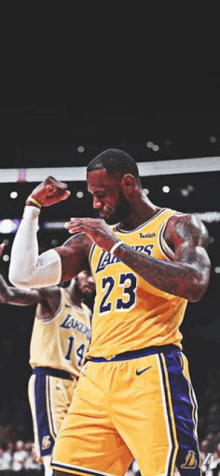 a basketball player is flexing his muscles on a court .