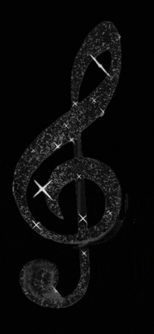 a black treble clef with sparkles on it