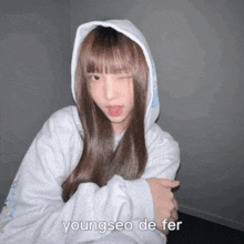 a young girl wearing a white hoodie with the name youngseo de fer on the bottom right