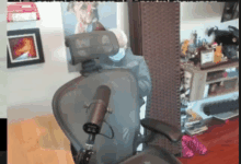 a chair with a microphone attached to it and a picture of bernie on the wall behind it