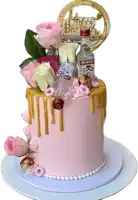 a pink cake with a bottle of smirnoff vodka on top