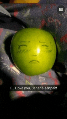 a green apple with a sad face drawn on it says i love you banana-senpai