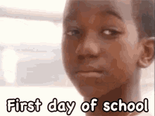 a young girl is making a funny face with the words `` first day of school '' written above her .