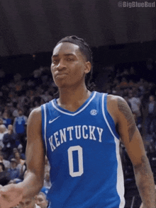 a kentucky basketball player wearing a blue jersey with the number 0