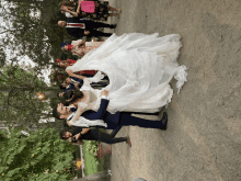 a bride and groom are posing for a picture with their wedding guests