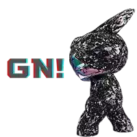 a black bunny figurine is standing in front of the word gn !