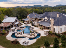 an aerial view of a large house with a swimming pool