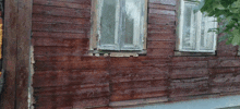 a wooden building with a window that is missing a frame