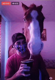 a man wearing a mask is standing next to a horse .