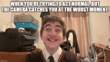 a picture of a boy with a caption that says " when you 're trying to act normal but the camera catches you