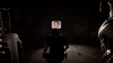 a screenshot of a video game shows a man looking at a screen with a picture of a face on it