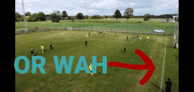 a group of soccer players are playing on a field with the words or wah above them